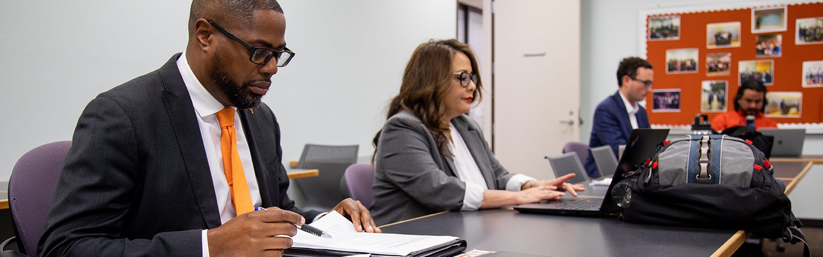 A group of graduate students takes notes during a Cooperative Superintendency Program seminar.